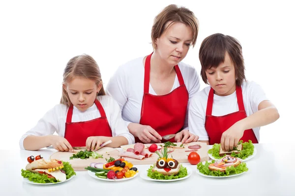 Kids and their mother preapring the party sandwiches — Stock Photo, Image