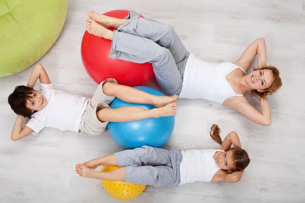 Abdominal workout - woman and kids doing gymnastic exercises — Stock Photo, Image