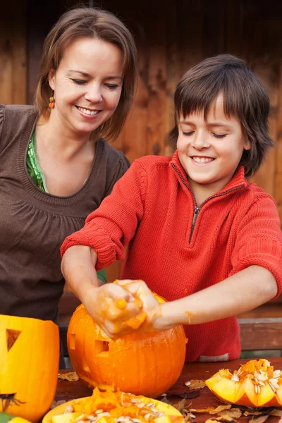 Boy having fun carving a jack-o-lantern for Halloween Stock Photo