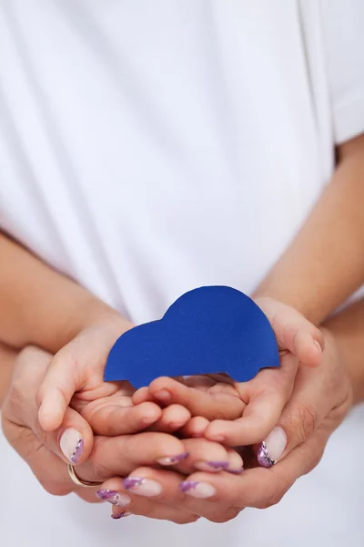 Child and adult hands holding car shaped paper — Stock Photo, Image