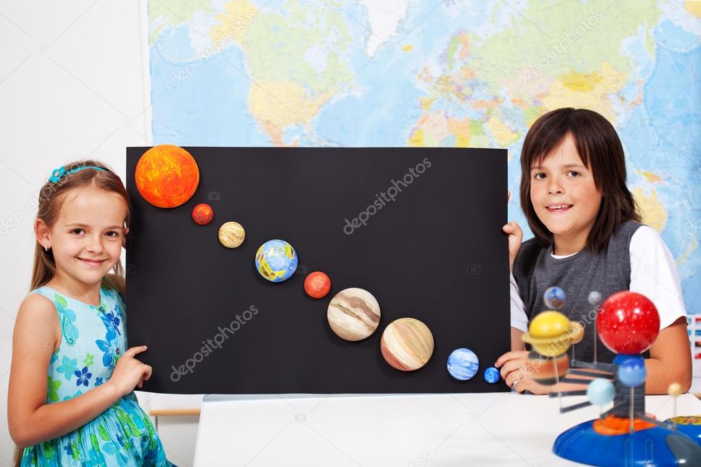 Kids in science class study the solar system