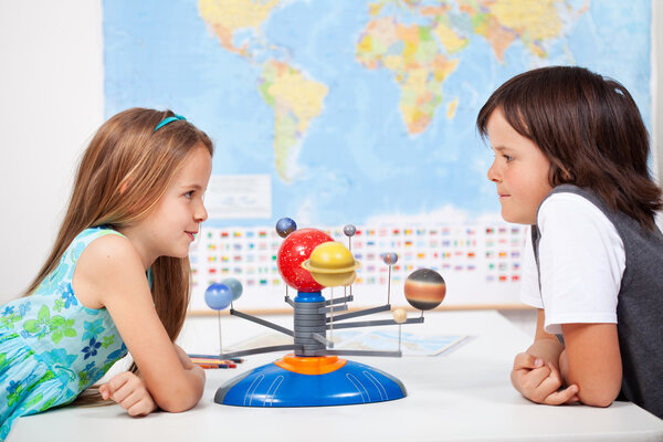 Kids with a scale model planetary system in science class