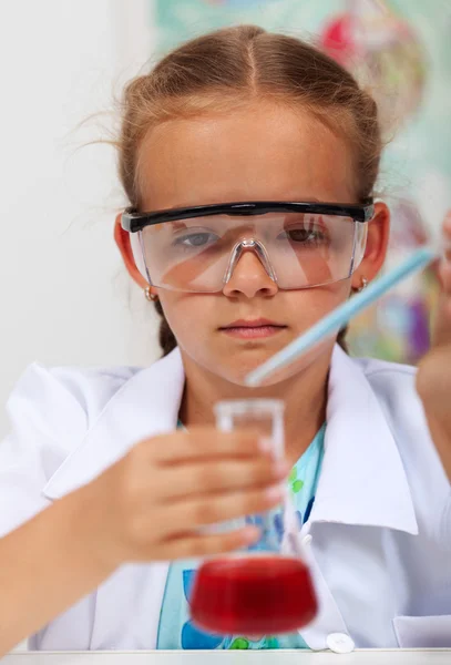 Young girl in elementary science class with chemical recipient a — Stock Photo, Image