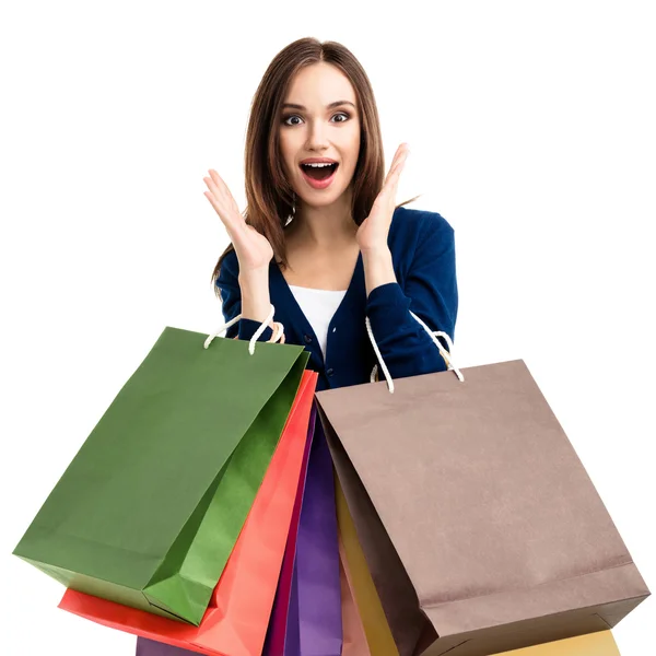 Mulher bonita em roupas casuais com sacos de compras, em branco — Fotografia de Stock