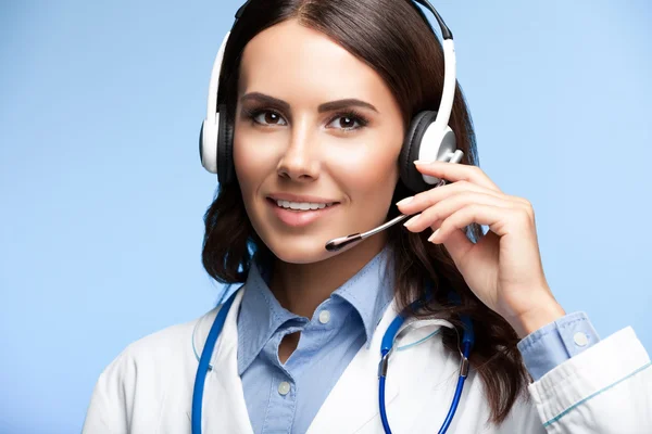 Happy smiling doctor in headset, on blue — Stock Photo, Image