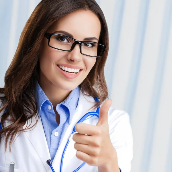 Doctor showing thumbs up gesture, at office — Stock Photo, Image