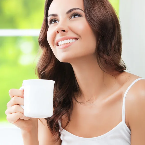 Kvinna som dricker kaffe eller te, hemma — Stockfoto