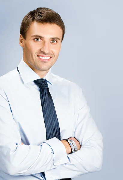 Portrait of business man, over grey background — Stock Photo, Image