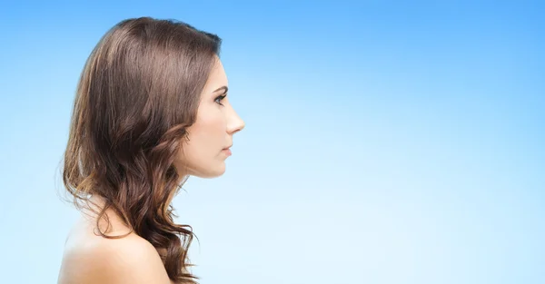 Portrait of beautiful woman, on blue — Stock Photo, Image