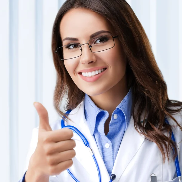 Doctor showing thumbs up gesture, at office — Stock Photo, Image