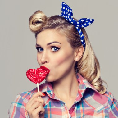 kadın beslenme kalp şekli lolipop, pin-up tarzı giyinmiş
