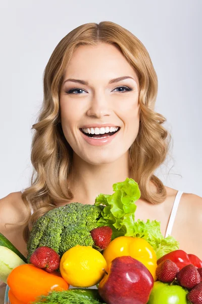 Young woman with vegetarian food, over gray — Stock Photo, Image