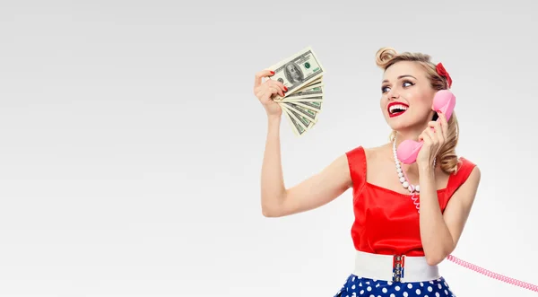 woman with money, talking on phone, dressed in pin-up style dres