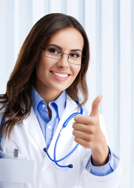 Doctor showing thumbs up gesture, at office — Stock Photo, Image