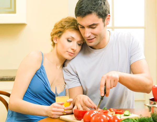 Cheerful young cooking couple at home — Stock Photo, Image