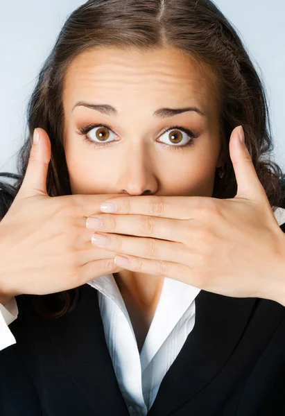 Business woman covering mouth, over blue — Stock Photo, Image