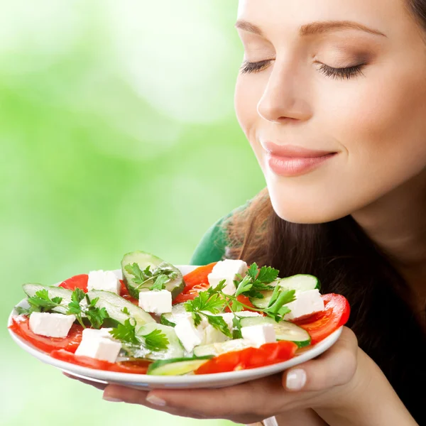 Portrait of happy smiling woman with plate of salad Royalty Free Stock Photos