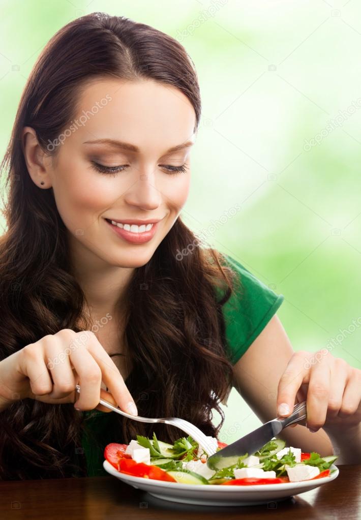 Young woman with salad, outdoor