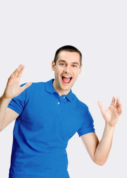 Surprised young man, against grey — Stock Photo, Image