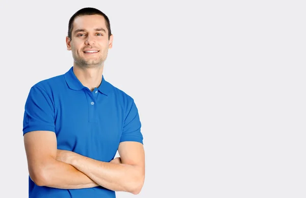 Smiling young attractive man, on grey — Stock Photo, Image