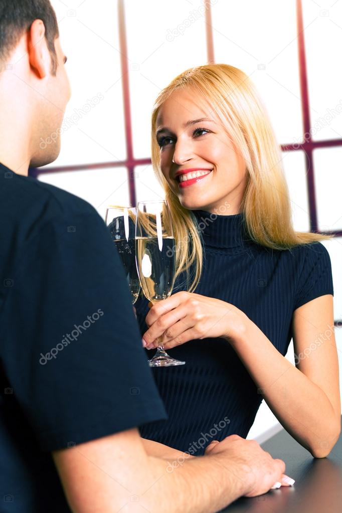 Young couple celebrating with champagne together