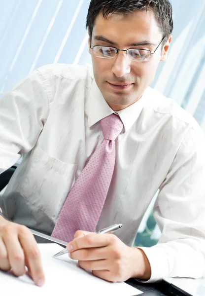 Writing businessman with document — Stock Photo, Image