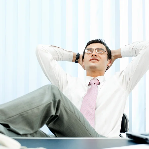 Relaxing young businessman at office — Stock Photo, Image