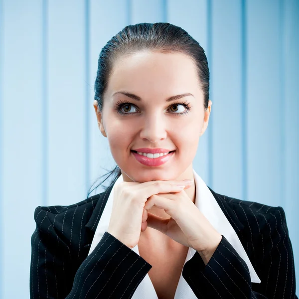 Closeup of thinking or dreaming businesswoman at office — Stock Photo, Image