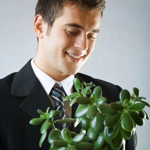 Businessman or student with flowerpot — Stock Photo, Image