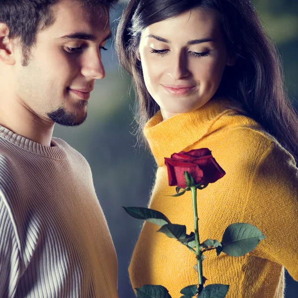 Young happy couple with rose, outdoor Stock Photo