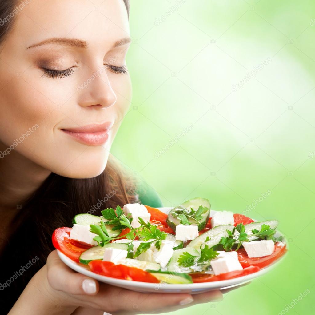 Young woman with plate of salad