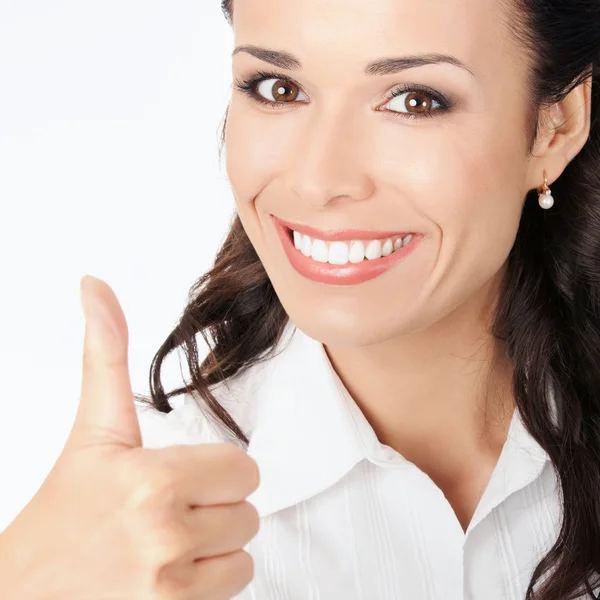 Businesswoman with thumbs up, on grey — Stock Photo, Image