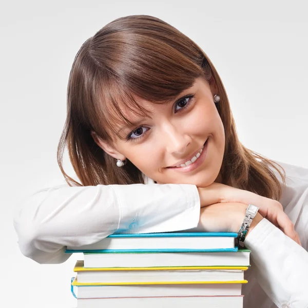 Joyeux sourire jeune femme avec des manuels scolaires — Photo