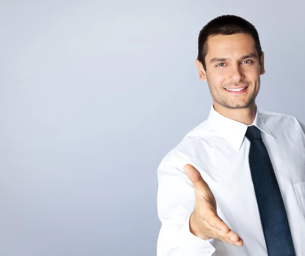 Businessman giving hand for handshake — Stock Photo, Image