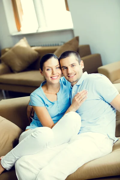 Cheerful smiling young attractive couple, indoors — Stock Photo, Image