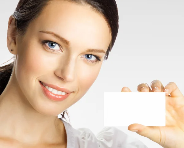 Businesswoman showing business or plastic credit card, on grey Stock Picture