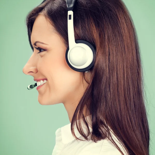 Support phone operator in headset, on green — Stock Photo, Image