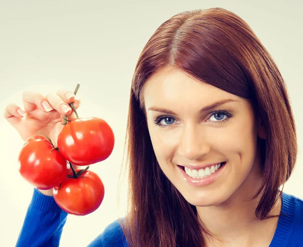 Portrait of young woman with tomatoes — Stock Photo, Image