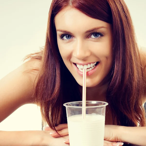 Portrait of cheerful young woman drinking milk Royalty Free Stock Images