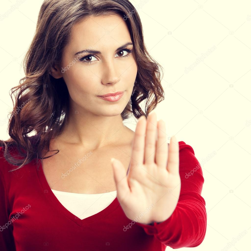 Young serious woman with stop gesture