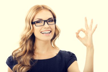 Young businesswoman in glasses with okay gesture clipart