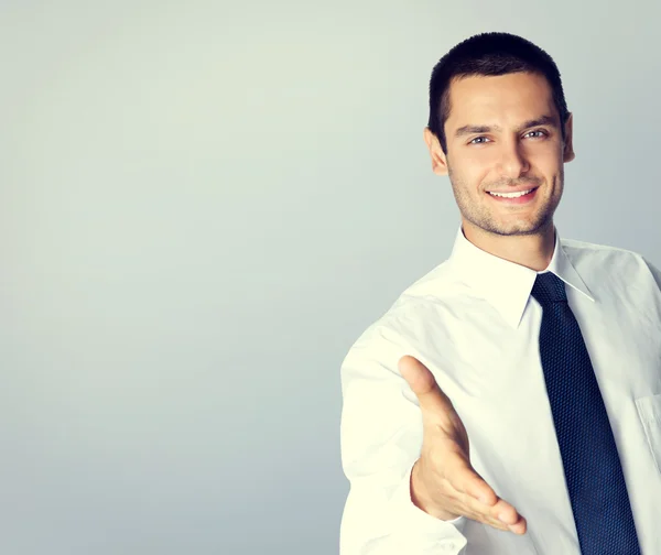 Young businessman giving hand for handshake — Stock Photo, Image