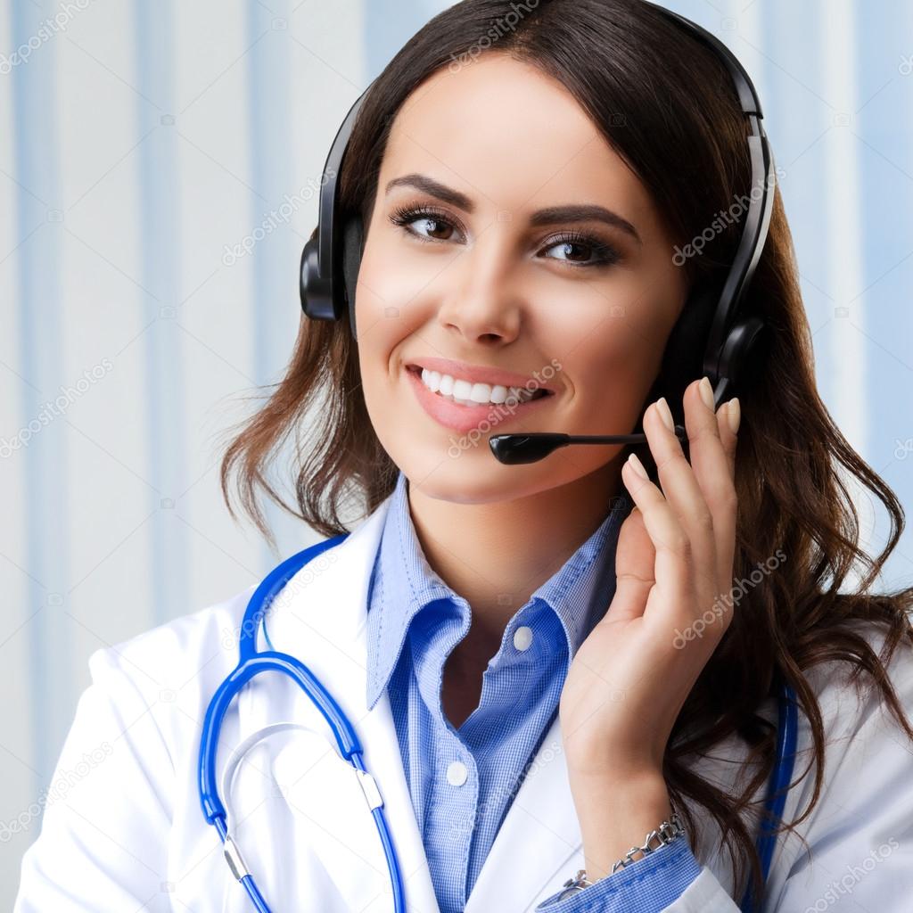 Smiling female doctor in headset, at office