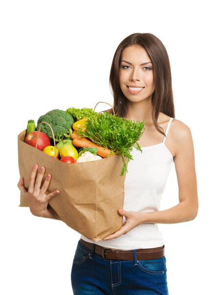 Smiling young woman holding grocery shopping bag with healthy ve