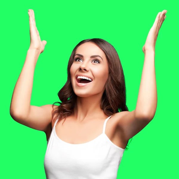 stock image Happy gesturing woman looking up, on green chroma key background