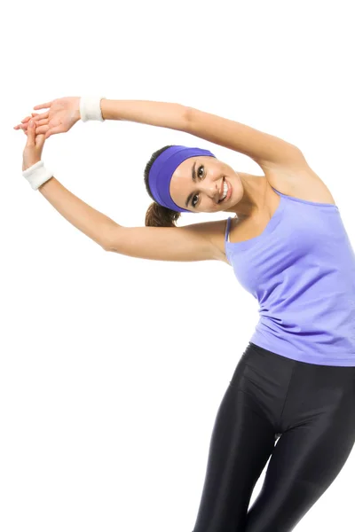 Smiling woman, in violet sportswear, doing stretching exercise o — Stock Photo, Image