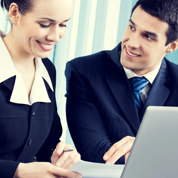 Businesspeople working with document at workplace Stock Photo