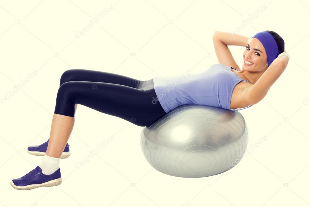 smiling woman in violet sportswear, doing fitness exercise on pi