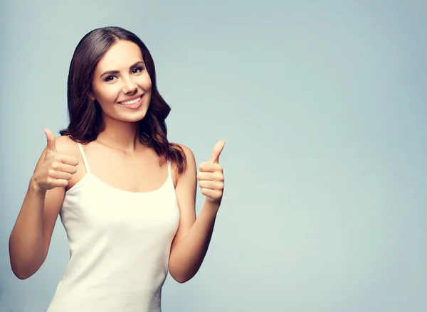 Portrait of happy woman showing thumb up gesture, with copyspace — Stok fotoğraf