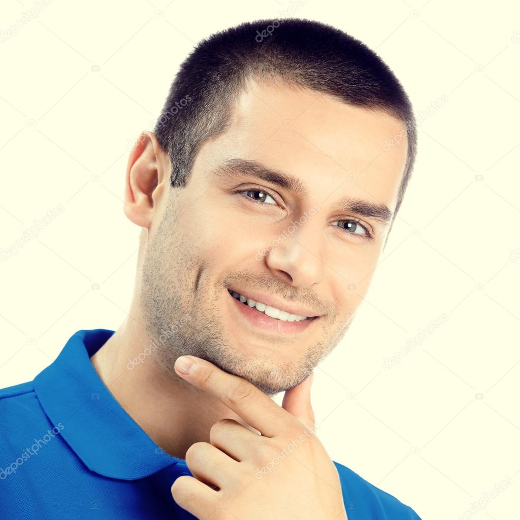 Portrait of cheerful thinking man looking at camera